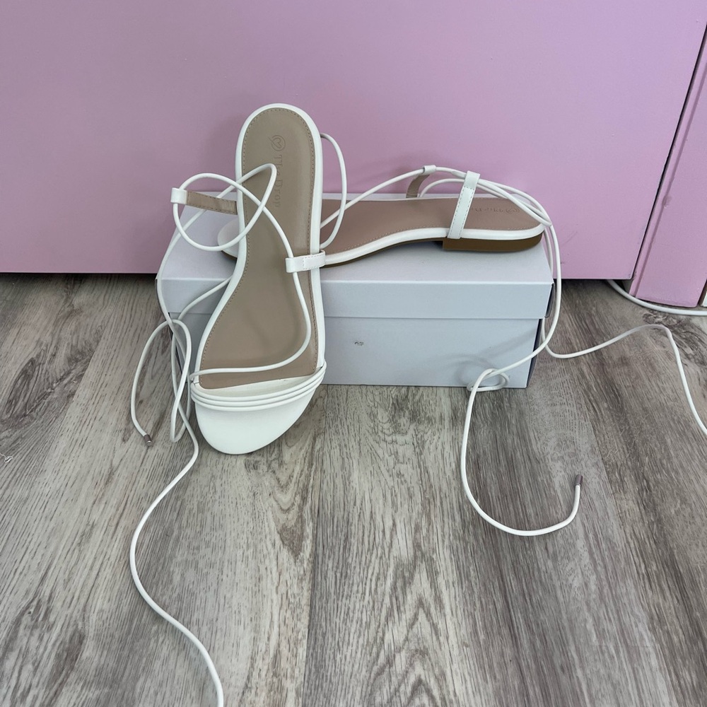 White wraparound flat sandals